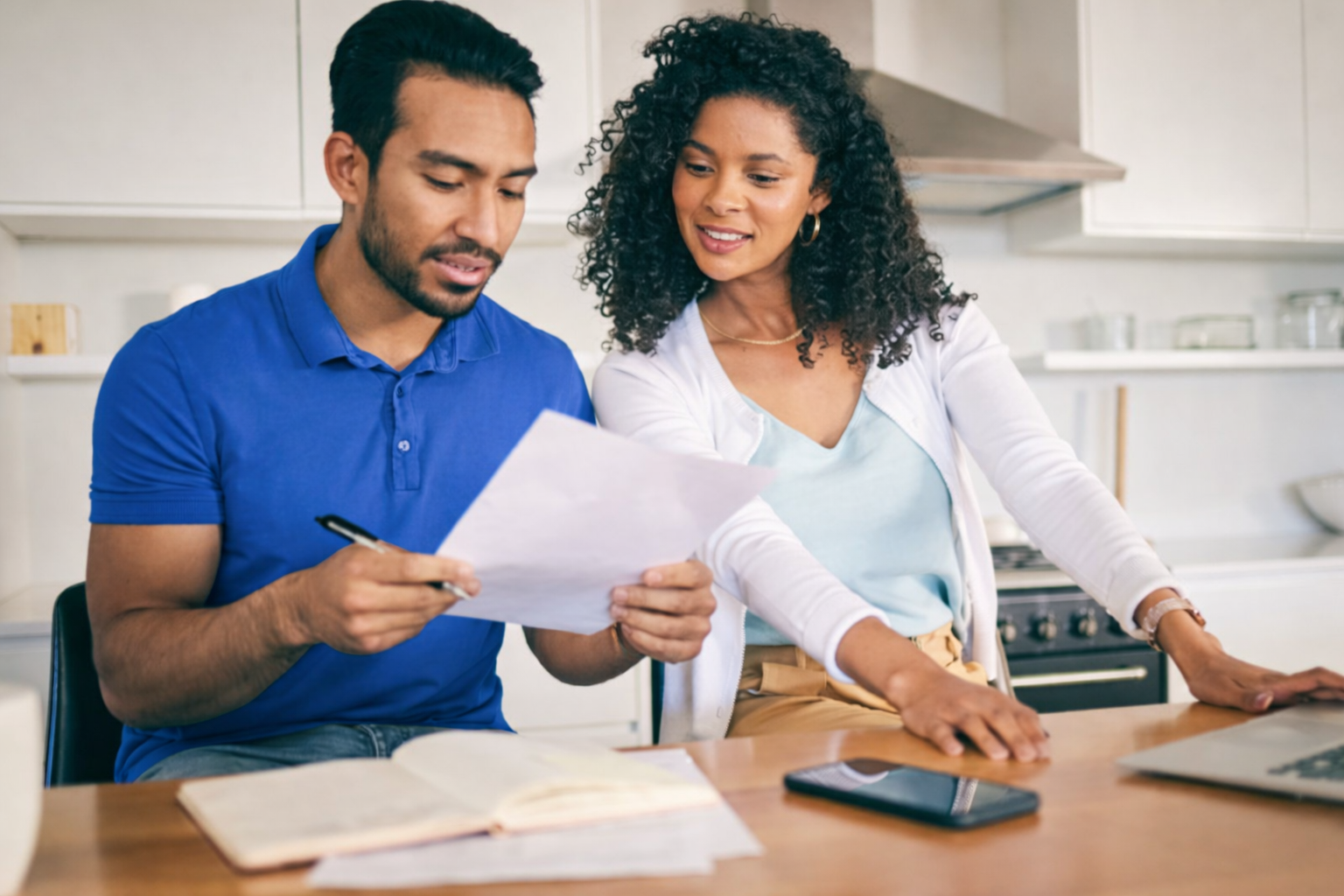 Couple reviewing documents with a real estate professional
